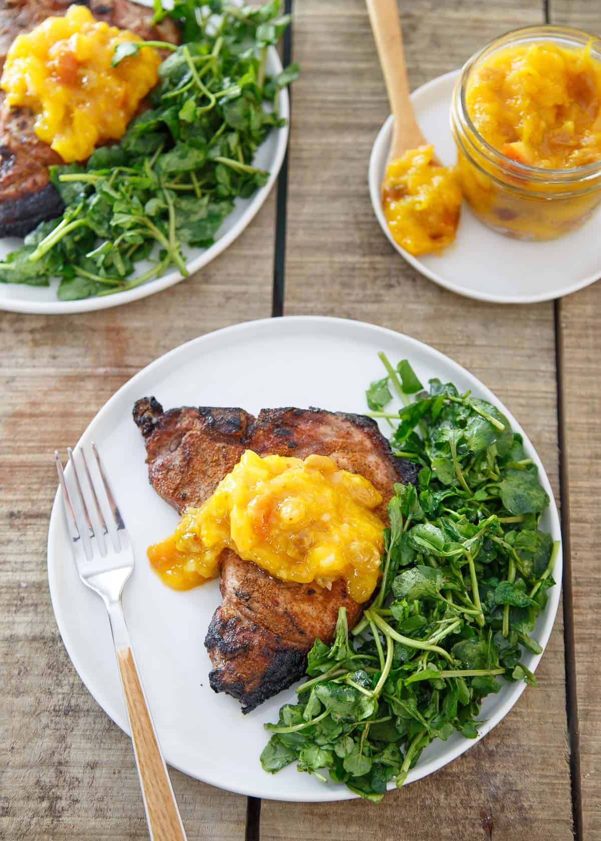 Thick cut bone-in pork chops are spice rubbed, grilled and topped with a mango peach chutney that brings the perfect sweetness to each bite.