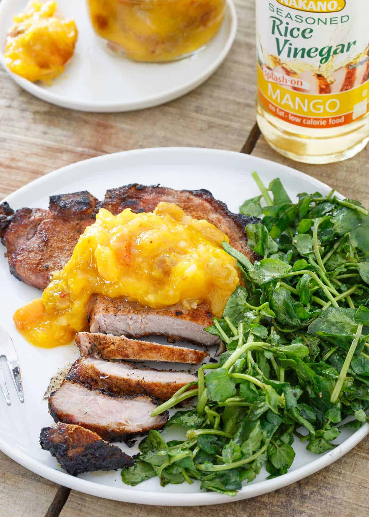 These grilled Spice Rubbed Pork Chops pair perfectly with the sweet mango peach chutney.