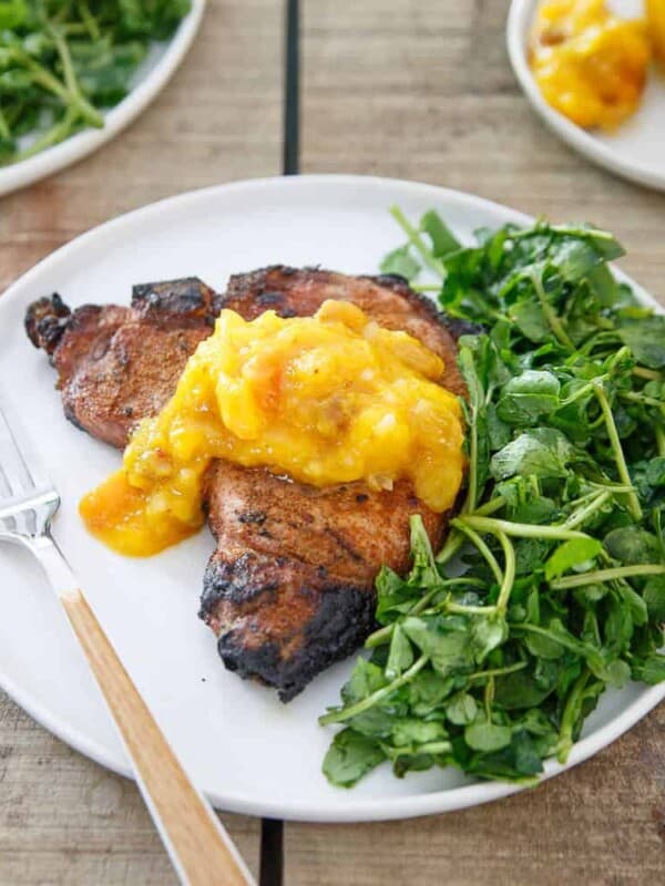Thick cut bone-in pork chops are spice rubbed, grilled and topped with a mango peach chutney that brings the perfect sweetness to each bite.