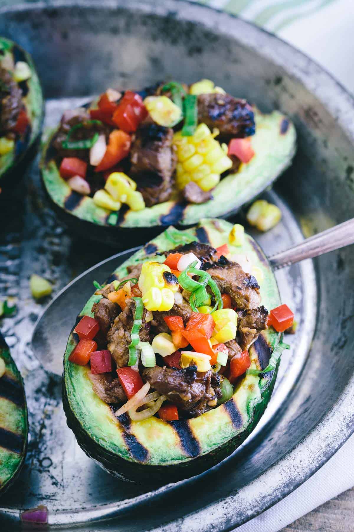 Marinate steak overnight, grill it up and stuff inside these grilled California avocados for an easy summer meal.