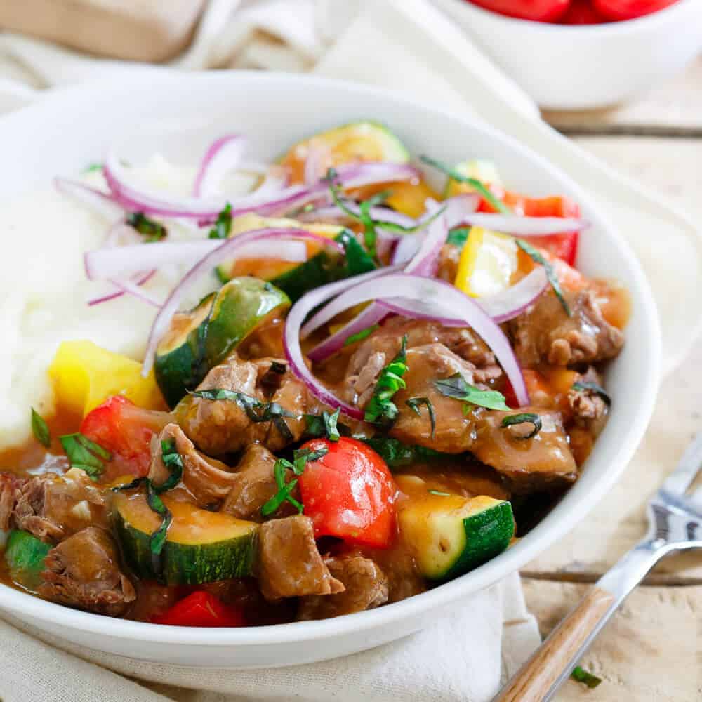 This summer beef stew is made in the slow cooker so the house stays cool. Enjoy this classic dish with a summer vegetable twist!