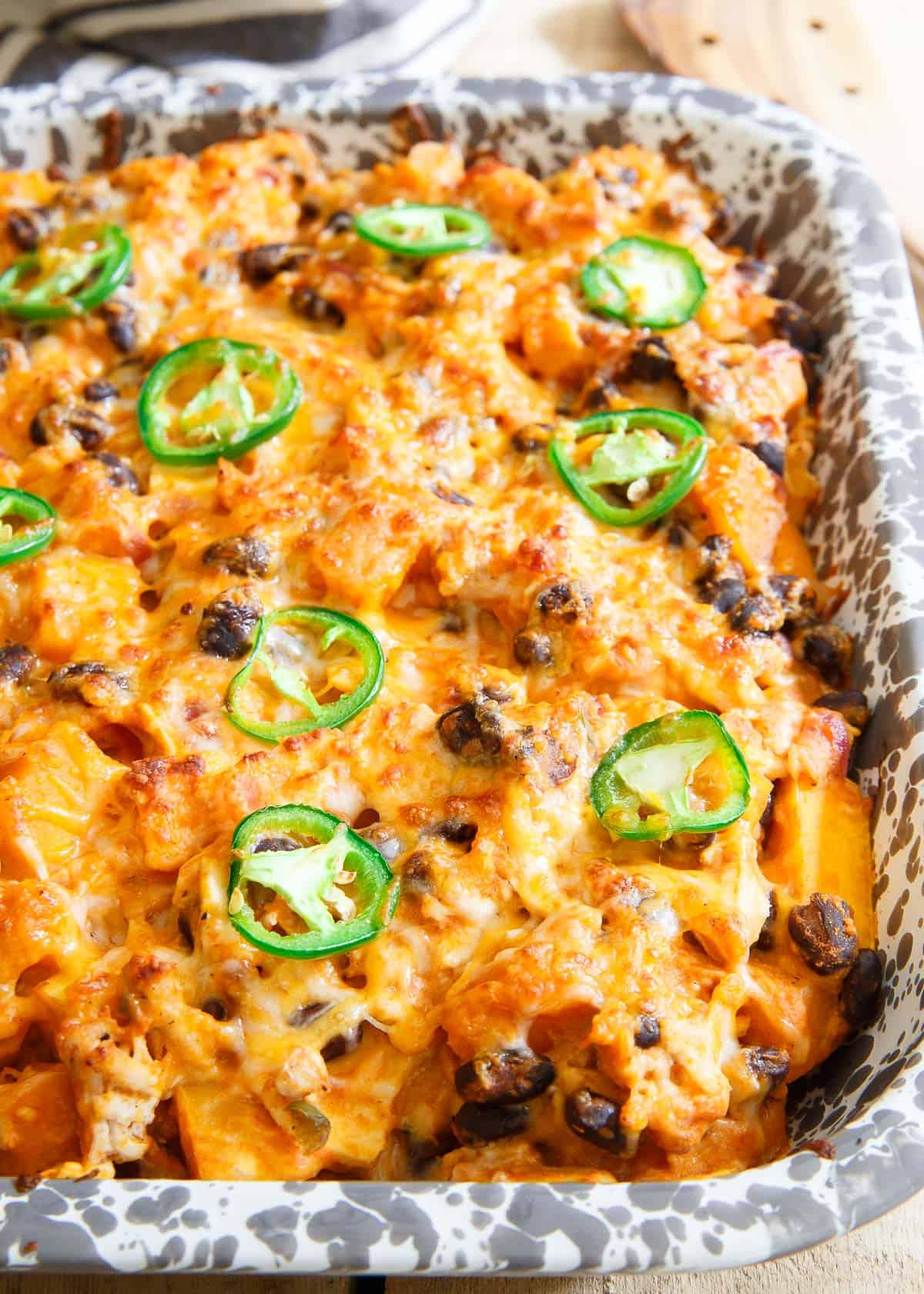 Savory pumpkin casserole topped with jalepeno slices