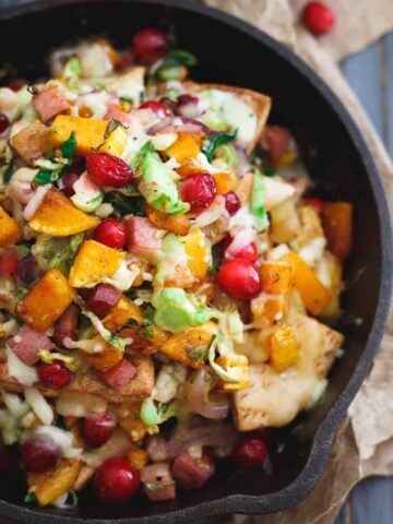 These butternut squash pita nachos bring a fall twist to the table packed with brussels sprouts, cranberries, pancetta and caramelized onions.