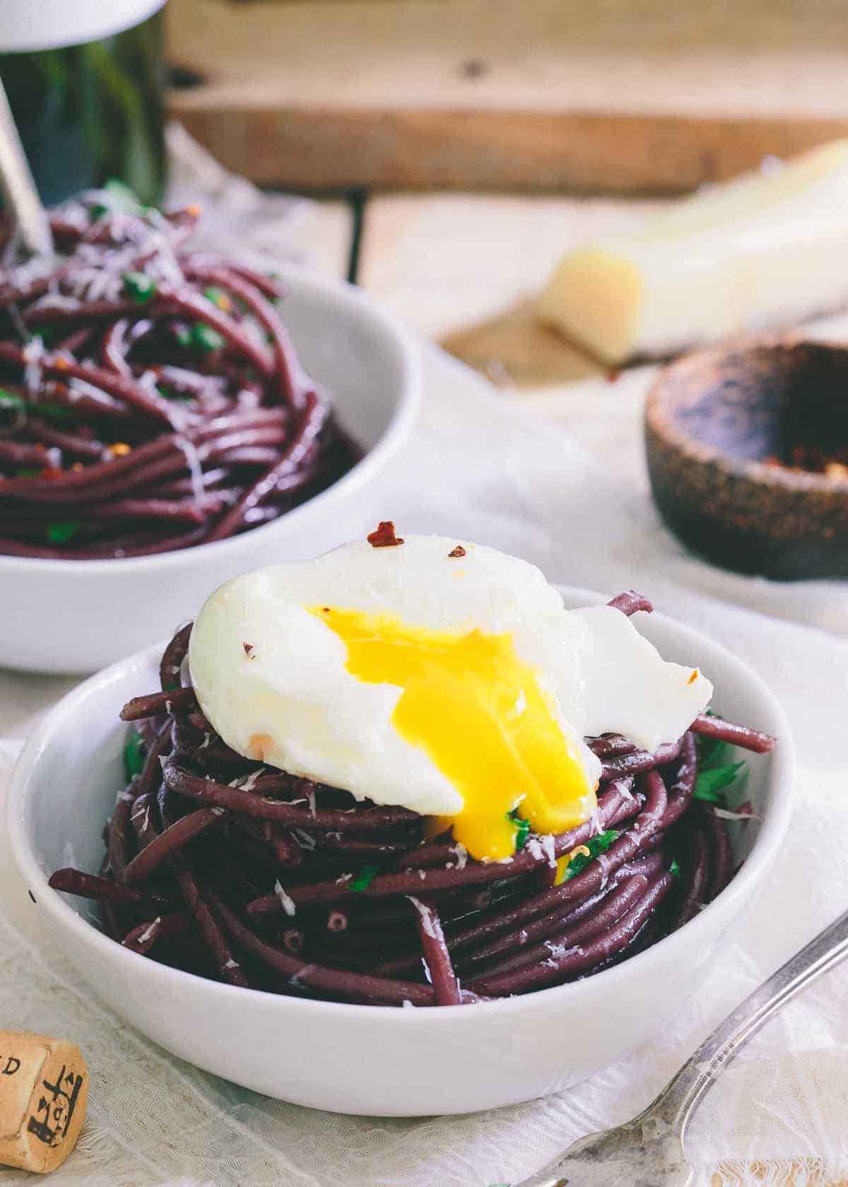 Top this red wine garlic bucatini with a soft boiled egg for a simple yet elegant dinner.