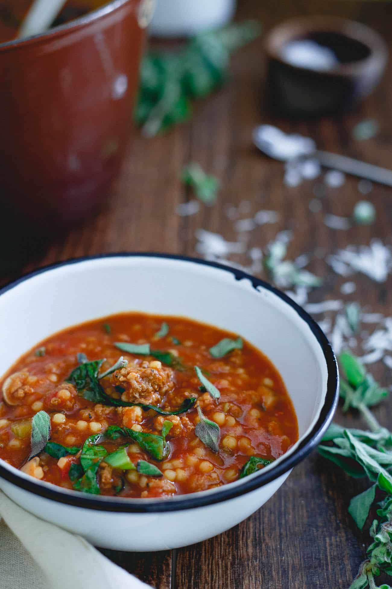 Italian tomato pasta soup is filled with hearty ground beef, sausage, mushrooms and escarole. It's the perfect bowl of comfort for the colder months ahead.