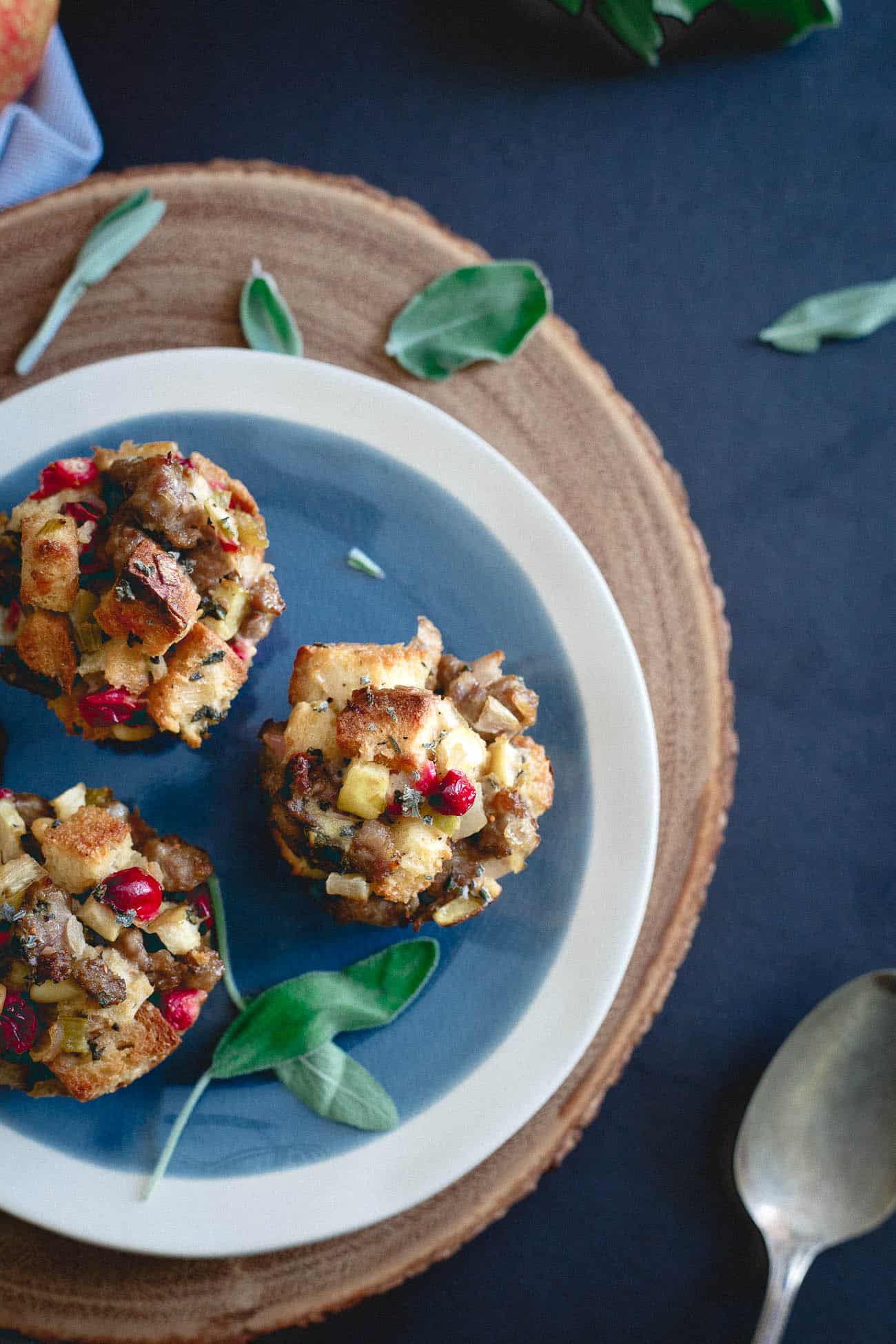 Top view of stuffing muffins on a white and blue plate.