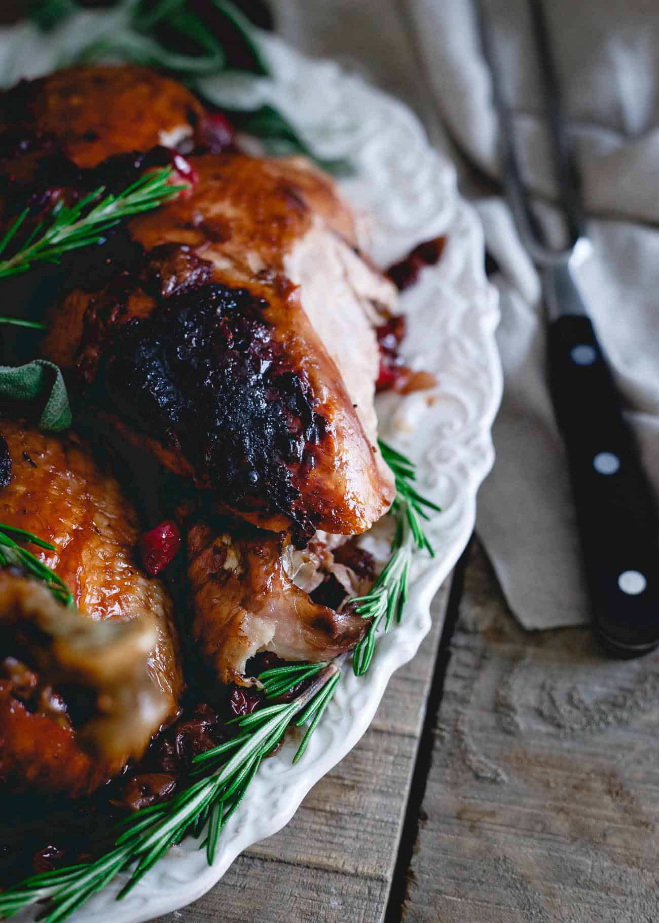 Basting this organic heirloom turkey in a cherry cranberry glaze makes for the most deliciously moist and flavorful turkey you'll have this holiday season!