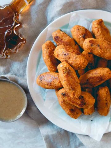 These baked sweet potato tots are infused with real maple syrup for a deep fall flavor and served with a dijon maple dipping sauce.