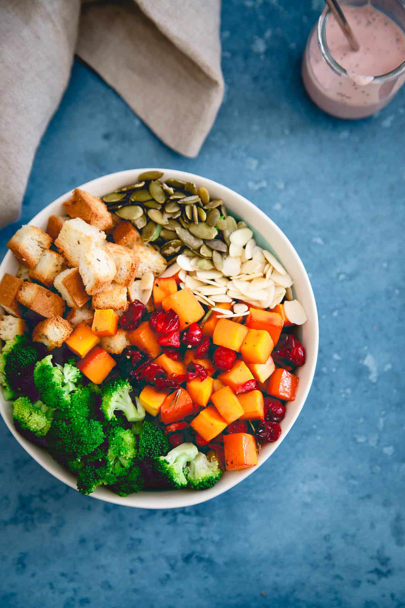 Broccoli cranberry salad in a bowl before tossing and adding the dressing.