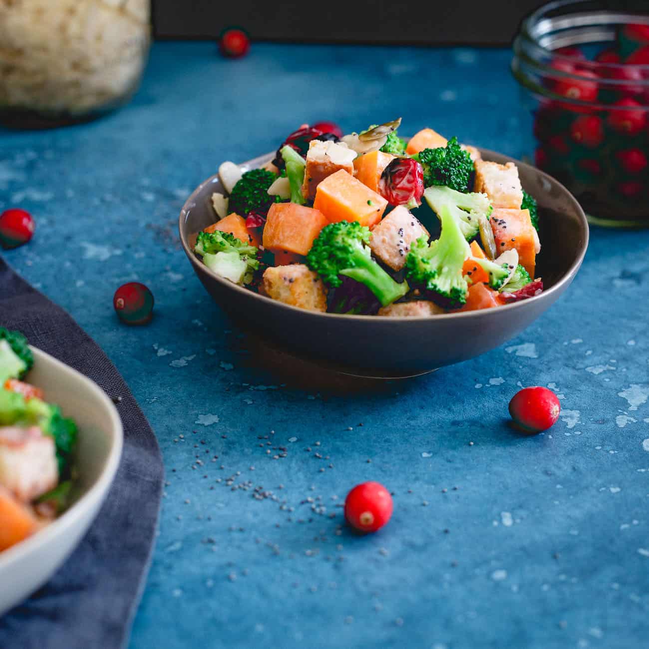 A small bowl of cranberry broccoli salad tossed in a poppyseed cranberry dressing.