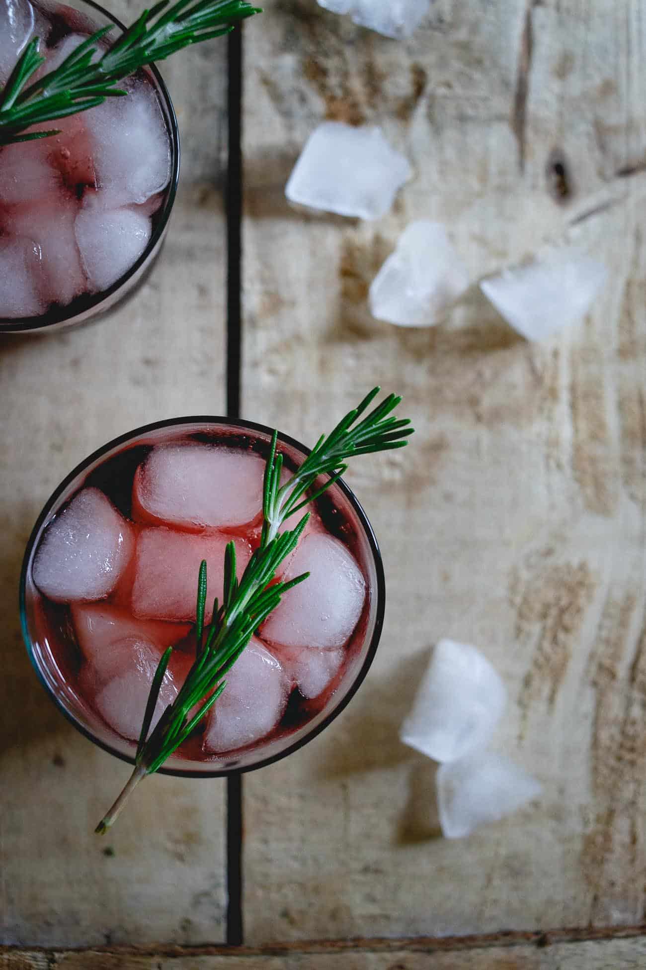 This red wine spritzer is made with tart cherry juice infused with rosemary. It's an easy holiday drink or fun way to change up your normal glass of red.