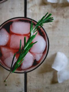 This cherry red wine spritzer is made with tart cherry juice infused with rosemary. It's an easy holiday drink or fun way to change up your normal glass of red.