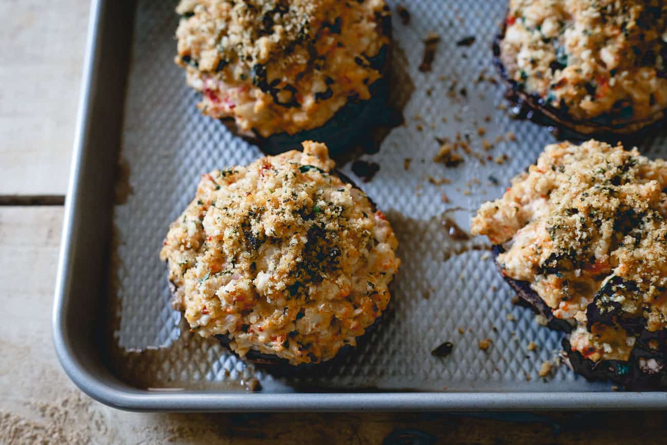 Close up of ground turkey stuffed mushrooms cooling on a pan after baking.