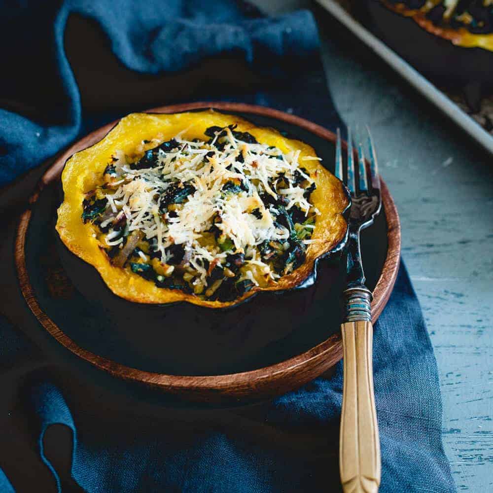 This twice baked acorn squash is stuffed with tuscan kale, hearty freekah and pecorino romano for a lovely fall side with a hidden protein boost.