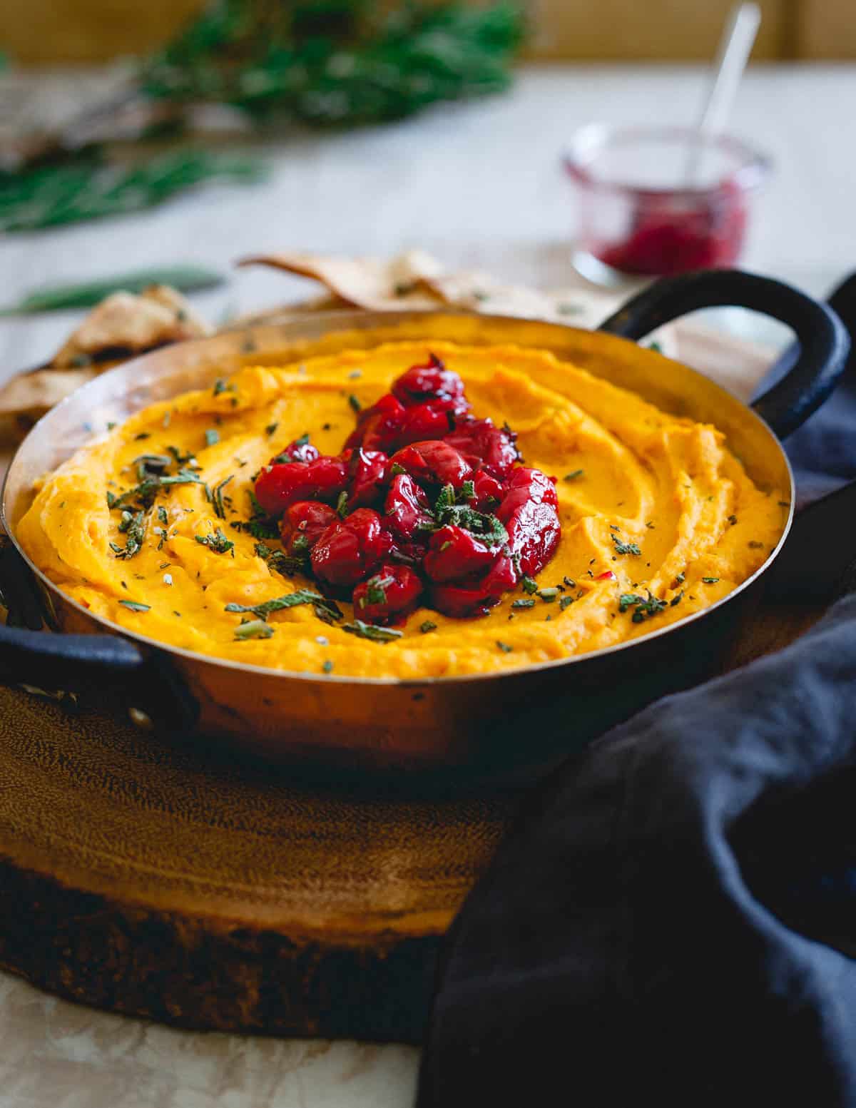 This butternut squash dip is made with goat cheese and cream cheese for a super creamy texture then topped with a festive tart cherry compote. Serve it with some pita chips for the perfect holiday appetizer!