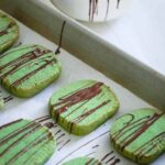 These chocolate drizzled matcha shortbread cookies are gluten-free, buttery, crispy and perfect for dunking in that cozy holiday cup of coffee or tea.