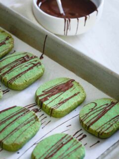 These chocolate drizzled matcha shortbread cookies are gluten-free, buttery, crispy and perfect for dunking in that cozy holiday cup of coffee or tea.