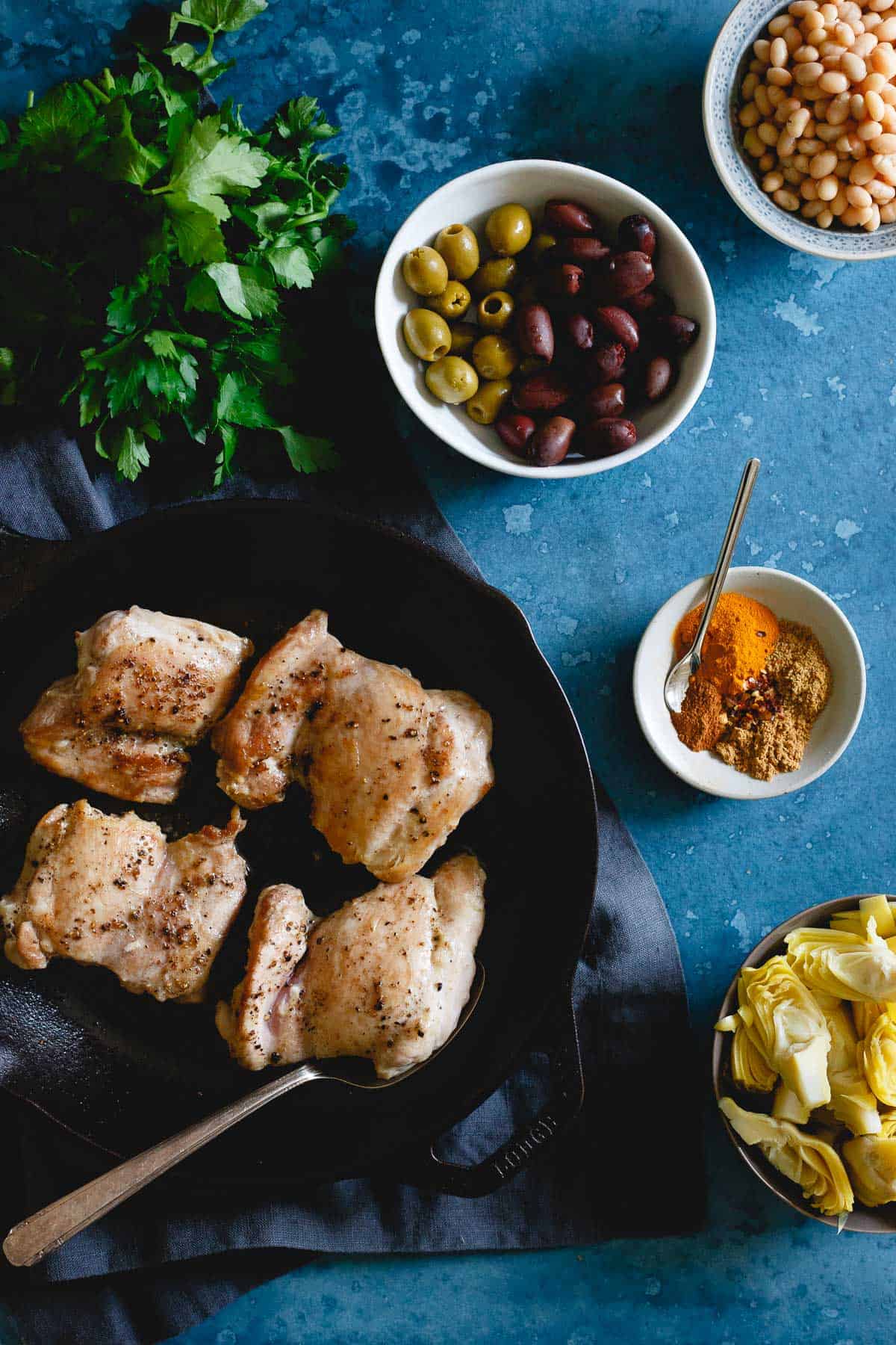 Packed with Mediterranean spices, olives, artichoke hearts and white beans, this chicken skillet is an incredibly flavorful and easy dinner!