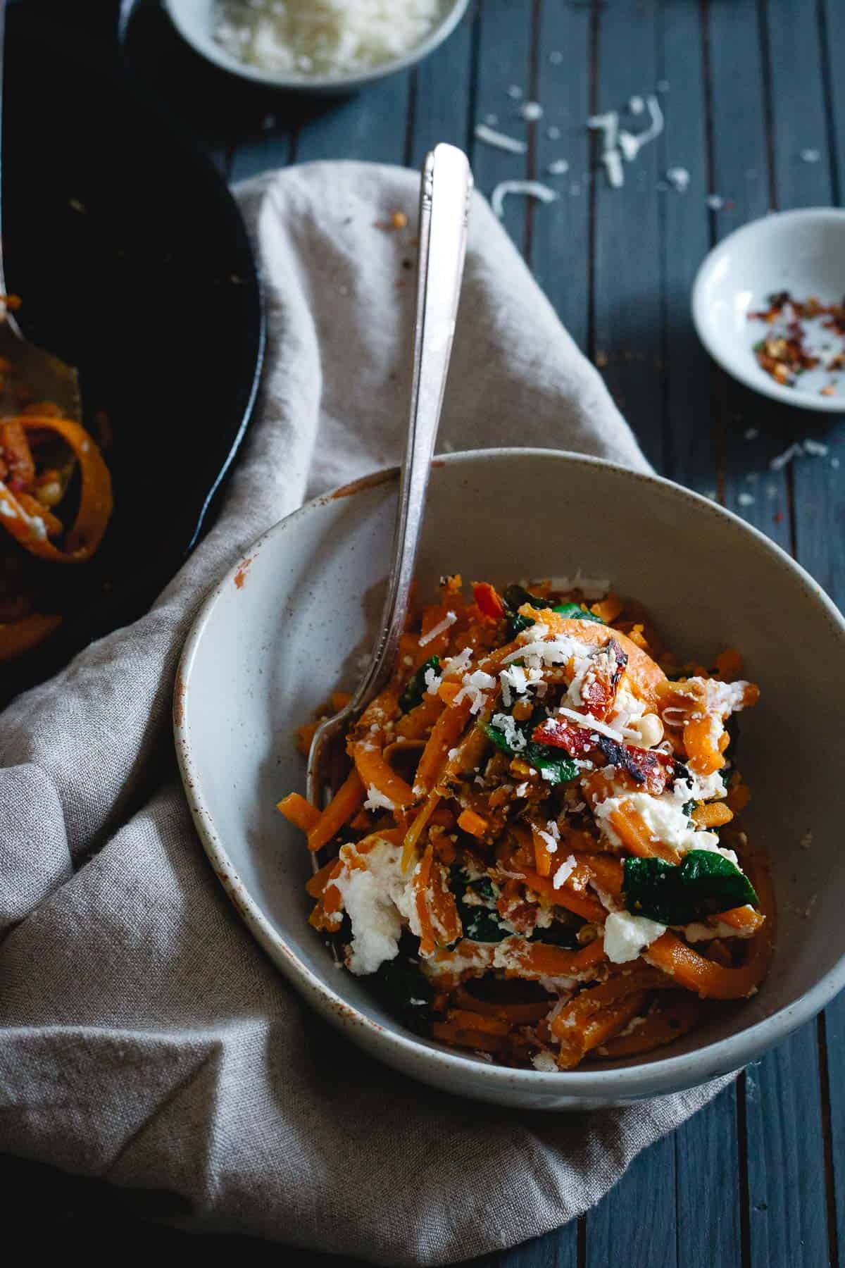Garlicky butternut squash noodles make a simple, cozy vegetarian, one-skillet meal packed with winter flavors.