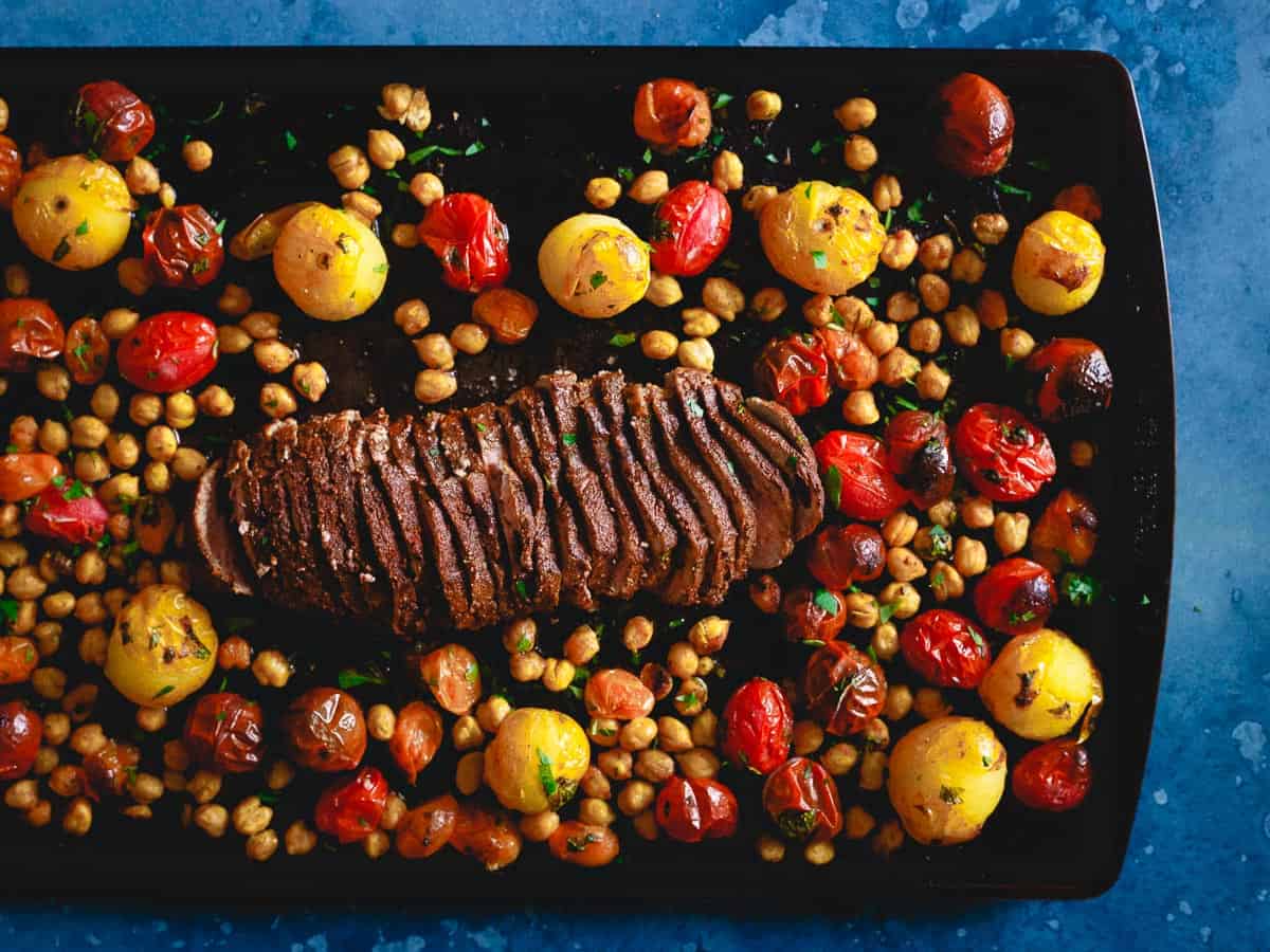 Sheet pan Mediterranean roasted lamb with tomatoes and chickpeas.