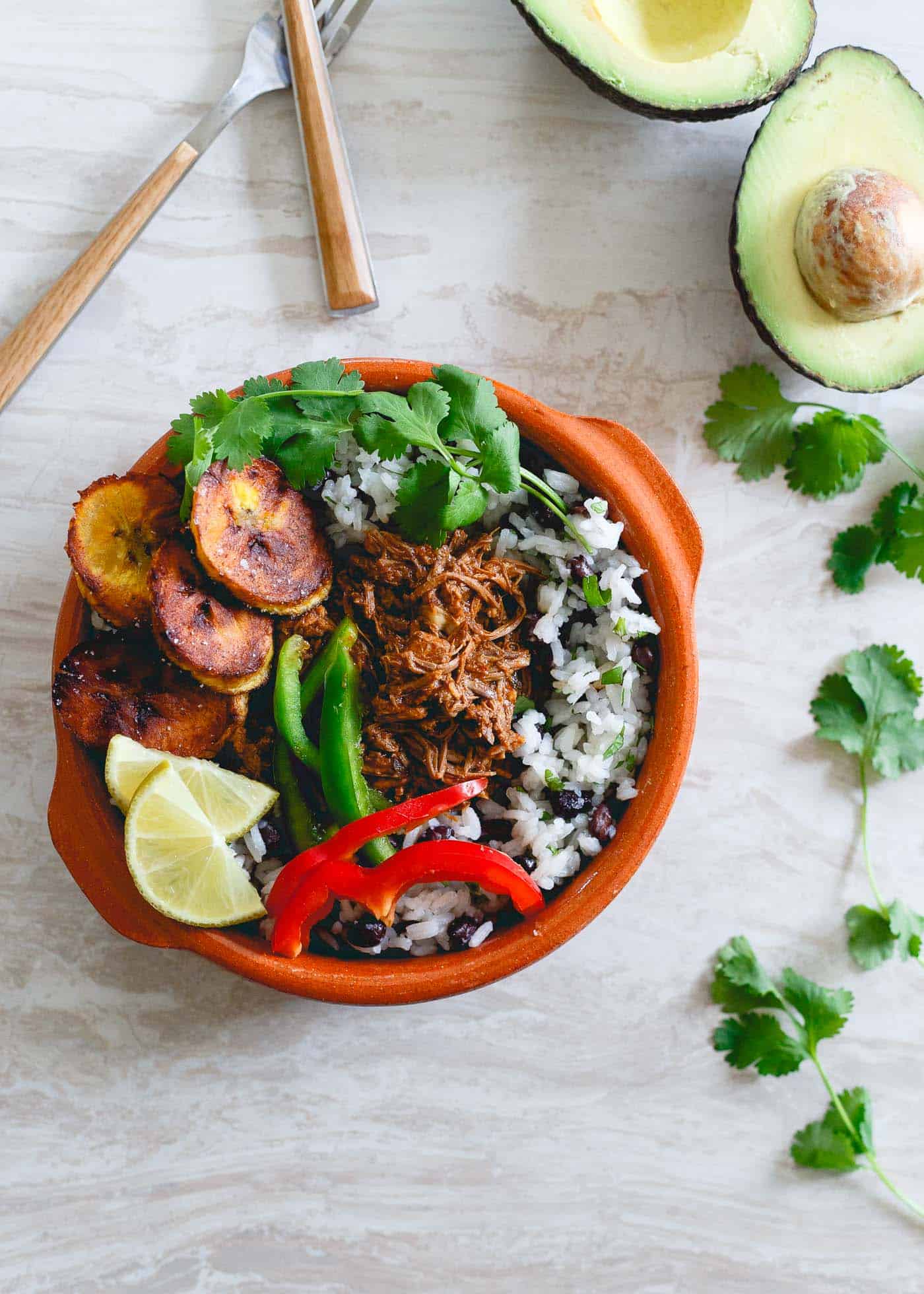 These shredded Mexican beef bowls are made in the slow cooker and perfect for weekly meal prep with rice, beans, plantains and peppers to round them out!