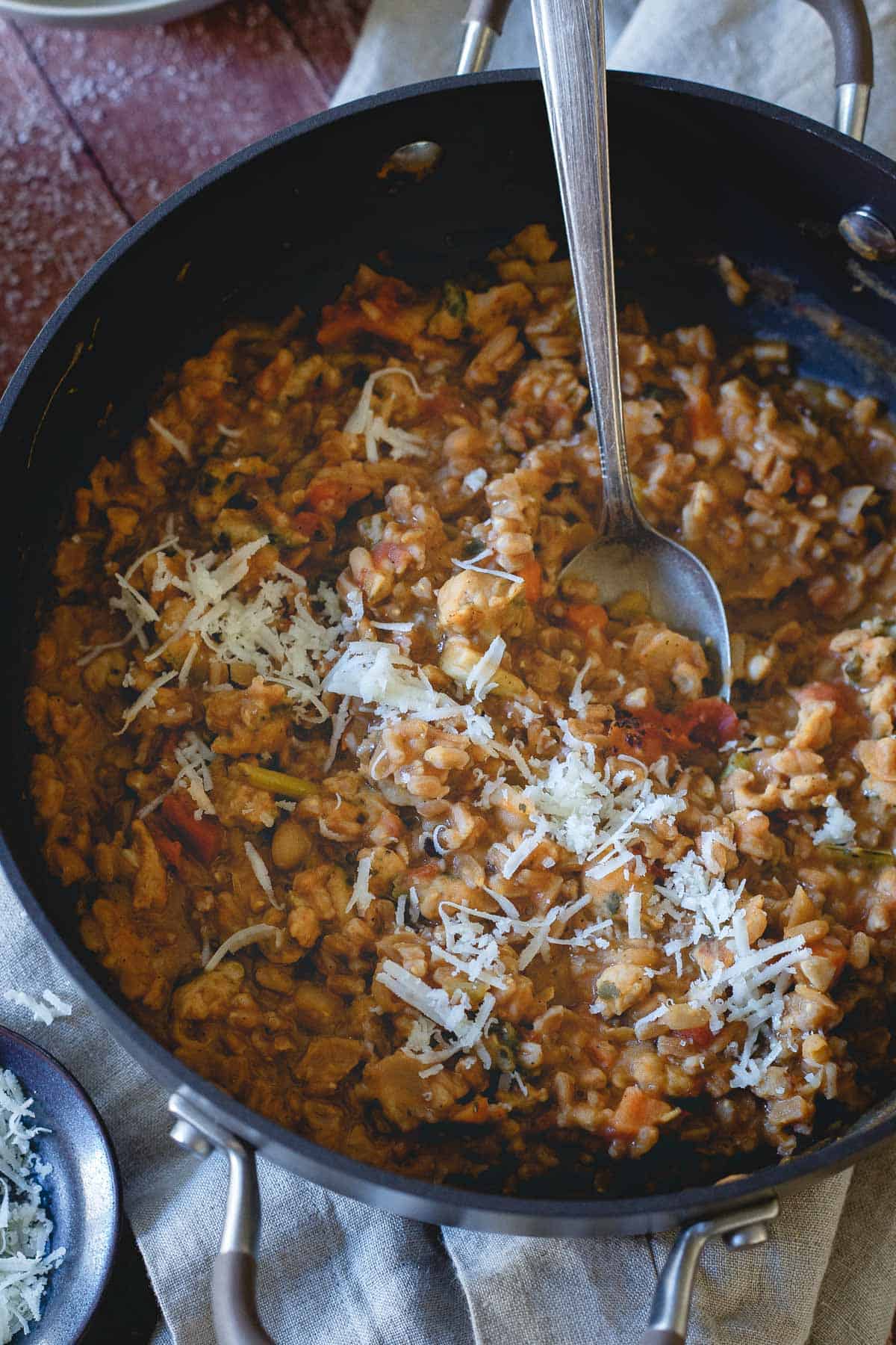 This tuscan white bean farro risotto is hearty, warming and packed with flavor from using soup as the cooking liquid instead of broth!