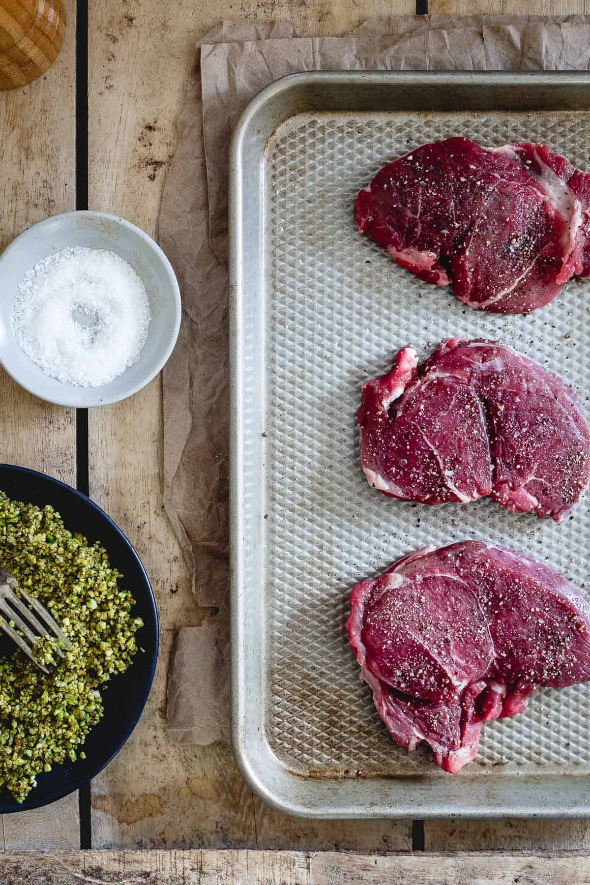 Sirloin lamb chops are coated in a pistachio crust and topped with red wine cherries for the ultimate Valentine's Day dinner.