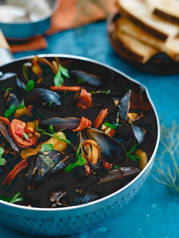 These chorizo chili mussels are an easy, one pot meal made in 20 minutes with spicy dried chilis, fennel and chorizo in a chunky tomato broth. Serve with some warm crusty bread for a seafood feast!