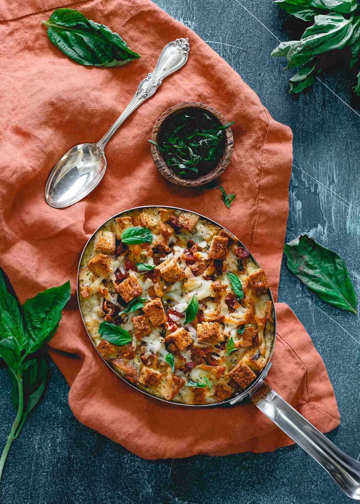 This everything bagel breakfast strata is perfect for Mother's Day. With bacon, cheese, basil and sun-dried tomatoes it's a delicious gluten-free brunch!