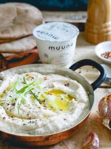 This roasted garlic white bean dip has a secret ingredient: cottage cheese! It lends a super creamy texture and healthy protein boost to each bite.
