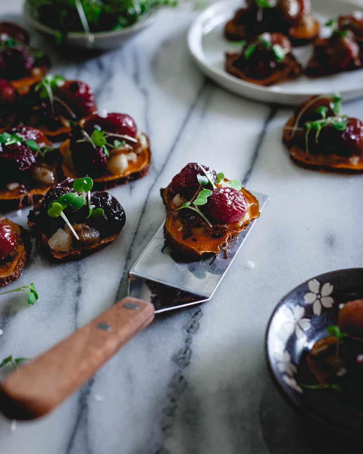 A party appetizer everyone can enjoy, these vegan, gluten-free sweet potato crostini have both sweet grapes and savory caramelized onions with a hint of spice. They're a flavor explosion! 