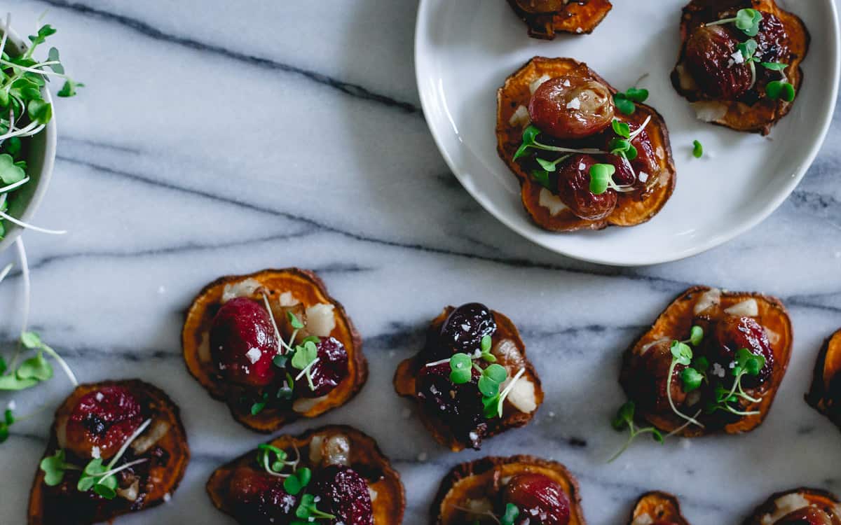 Sweet Potato rounds are roasted until crispy and topped with roasted grapes, caramelized onions and a spicy jalapeno havarti style cheese for a delicious savory sweet bite!
