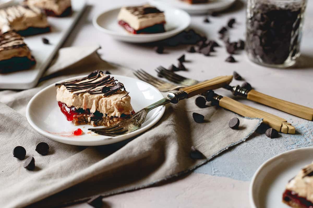 Chocolate peanut butter and jelly frozen yogurt bars on a plate with a spoon.