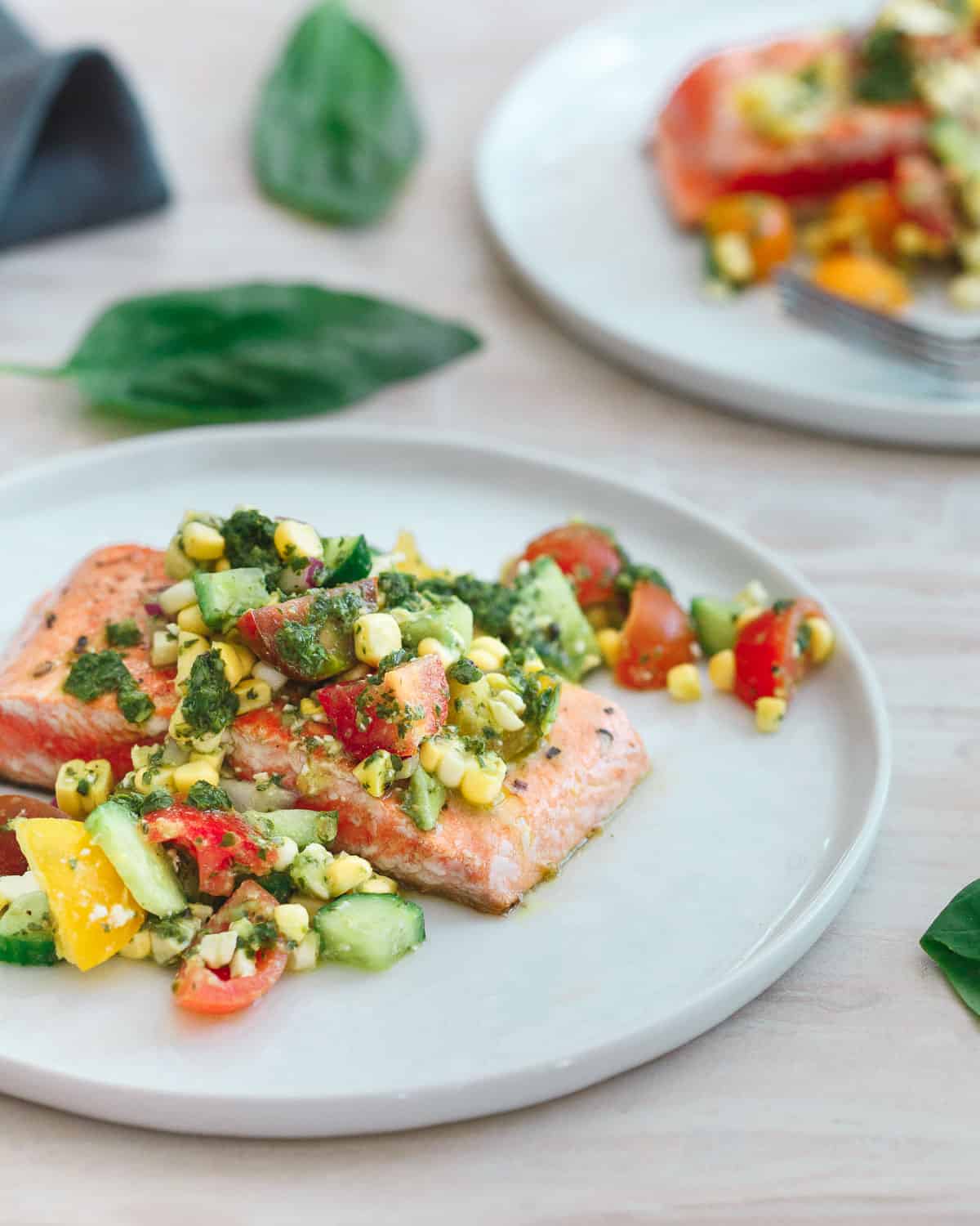 This salmon with tomato corn salsa is quickly seared on a hot a skillet and served with a refreshing salsa bursting with summer produce!