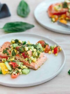 This salmon with tomato corn salsa is quickly seared on a hot a skillet and served with a refreshing salsa bursting with summer produce!