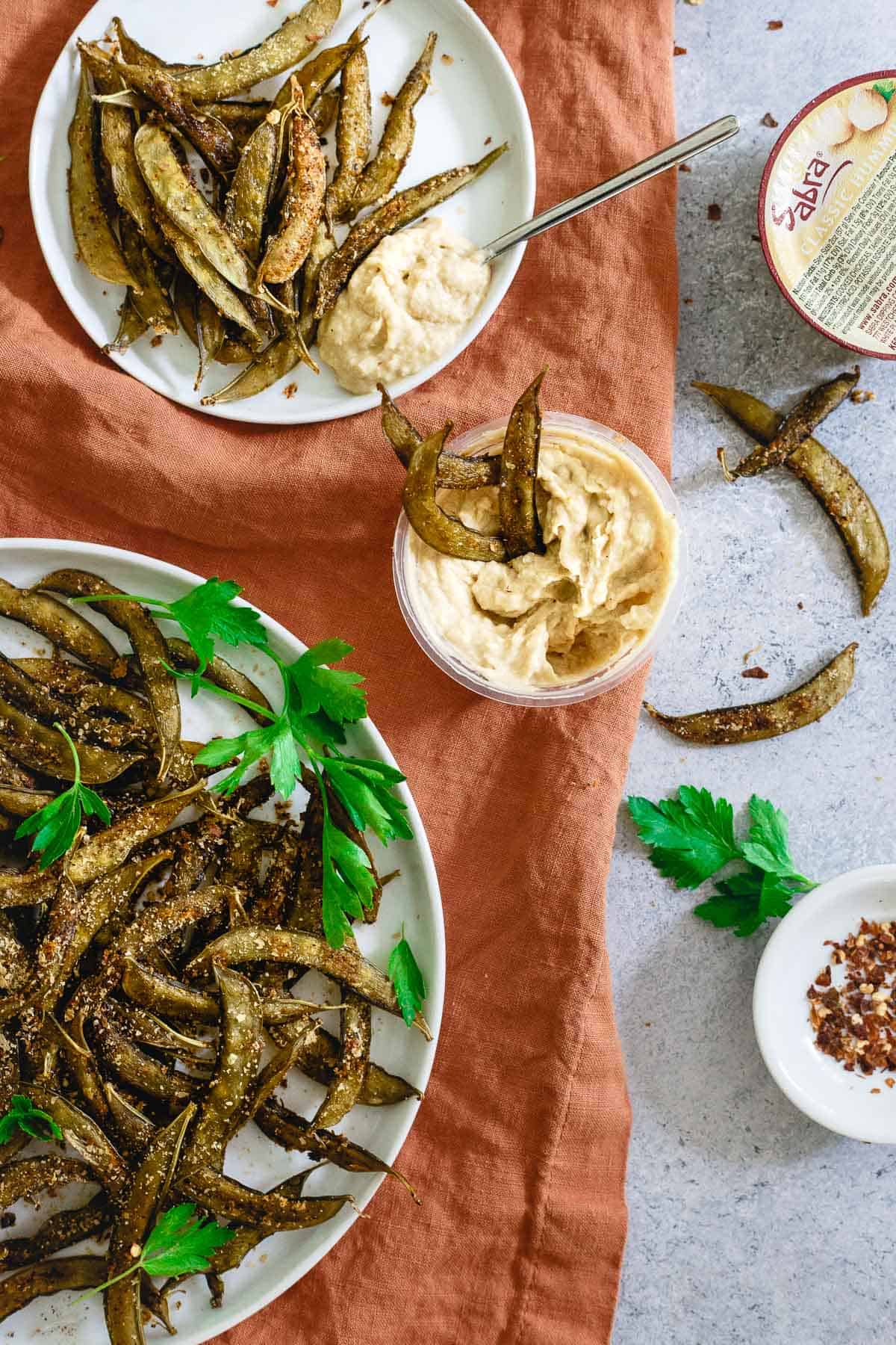 Creamy hummus and homemade snap pea crisps are a great way to keep things healthy when snacking.