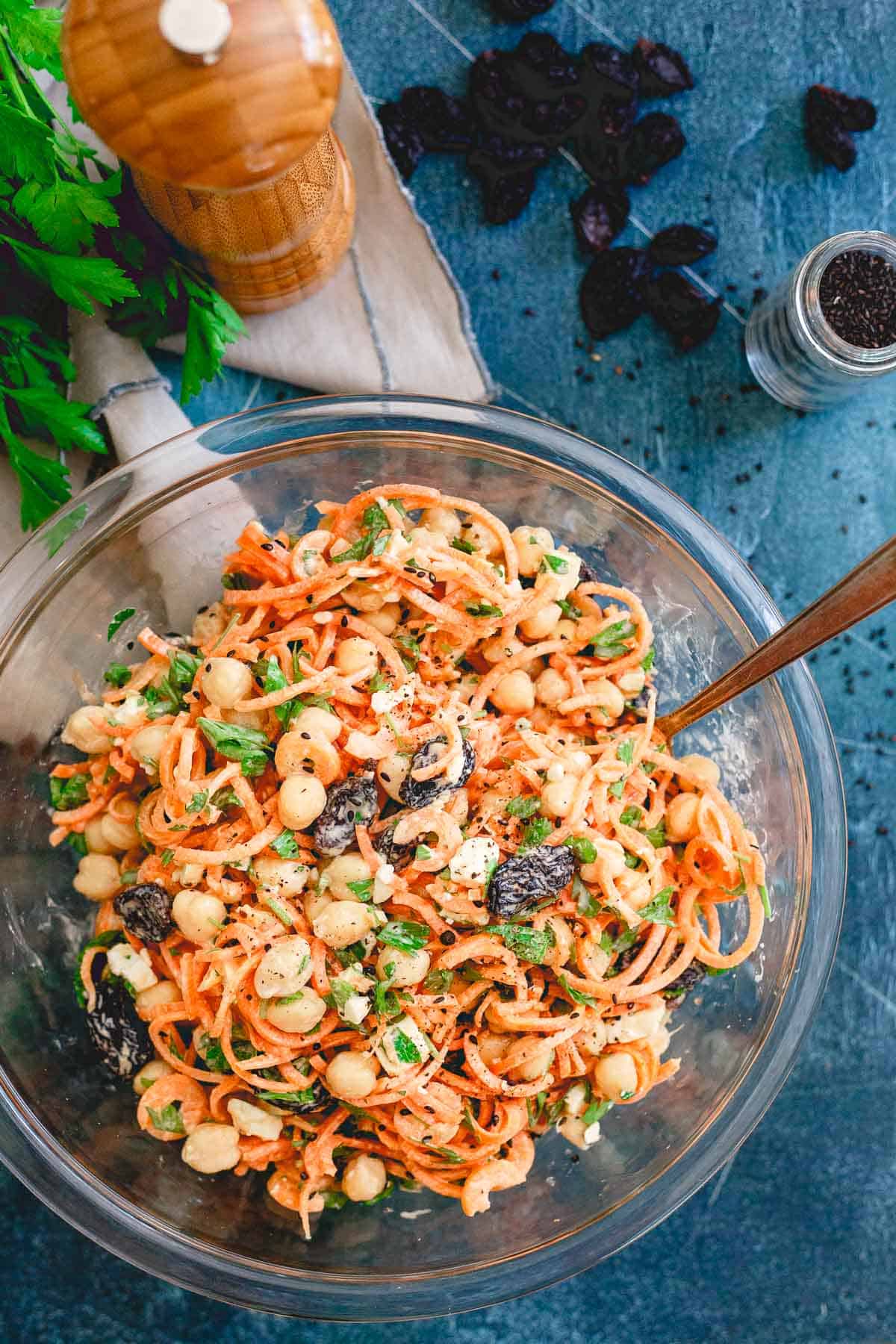 This mediterranean carrot salad is filled with chickpeas, royal raisins, feta, parsley and tossed with a creamy yogurt tahini dressing. Makes a great side salad for any cookout this summer!