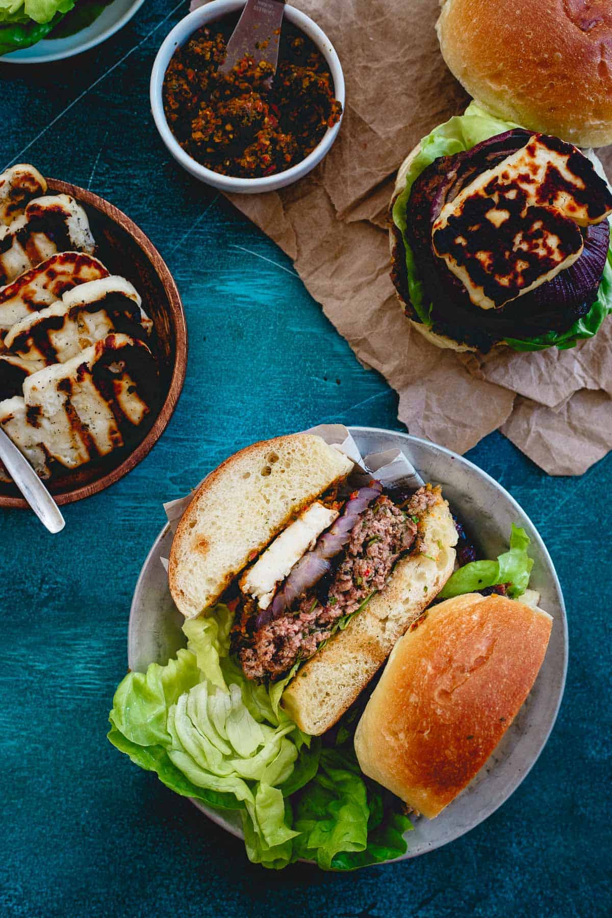 These lamb burgers are packed with fresh herbs, grilled red onions, a Mediterranean sun-dried tomato pesto spread for a nice change of pace to your summer burger.