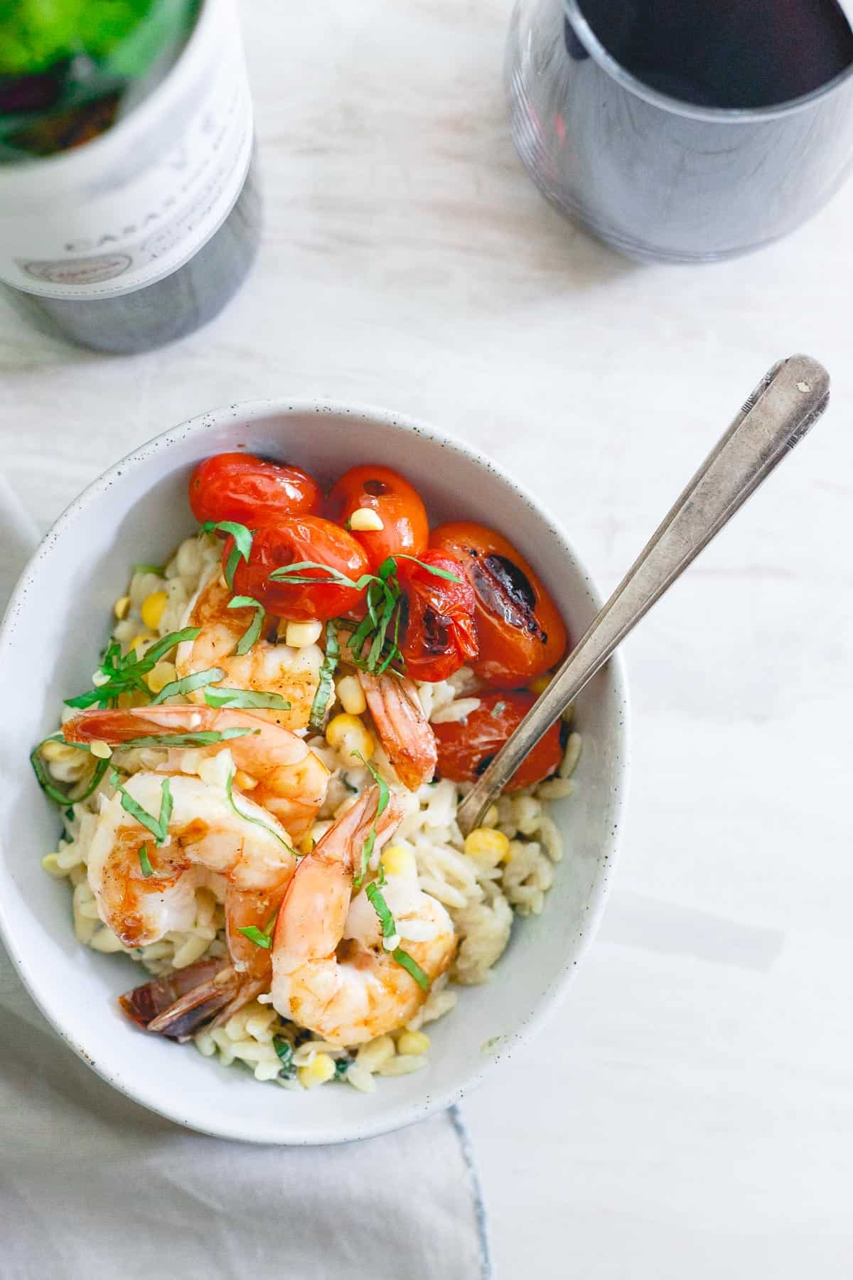 This brown butter shrimp is served on top of a creamy parmesan basil corn orzo and blistered cherry tomatoes for the perfect summer date night meal.