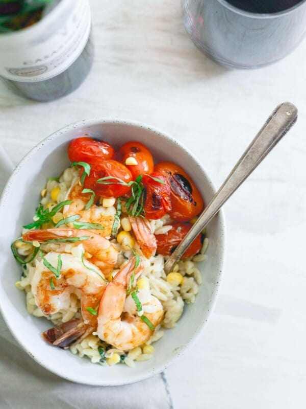 This brown butter shrimp is served on top of a creamy parmesan basil corn orzo and blistered cherry tomatoes for the perfect summer date night meal.