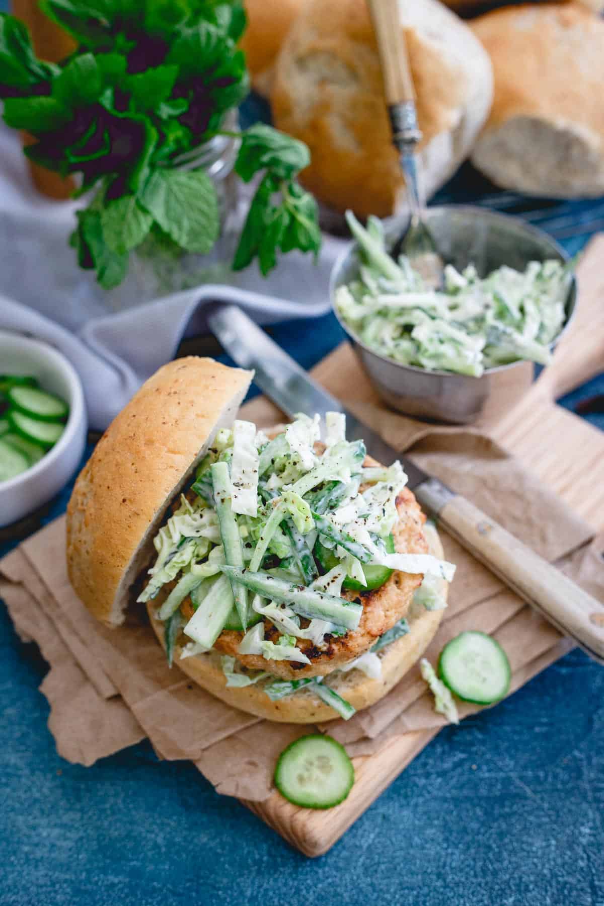 These Indian chicken burgers are topped with a refreshing yogurt cucumber slaw. Perfect beef alternative to throw on the grill.