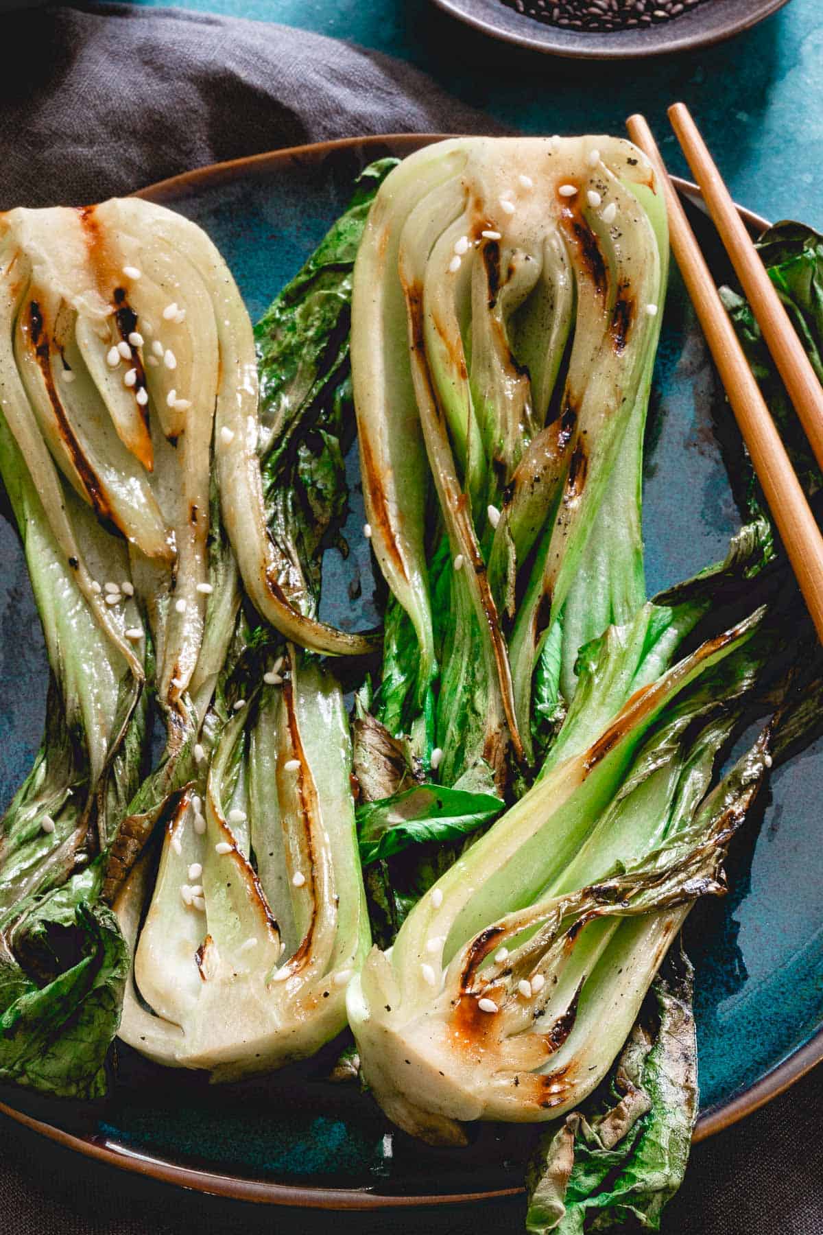 Grilled baby bok choy on a serving dish.