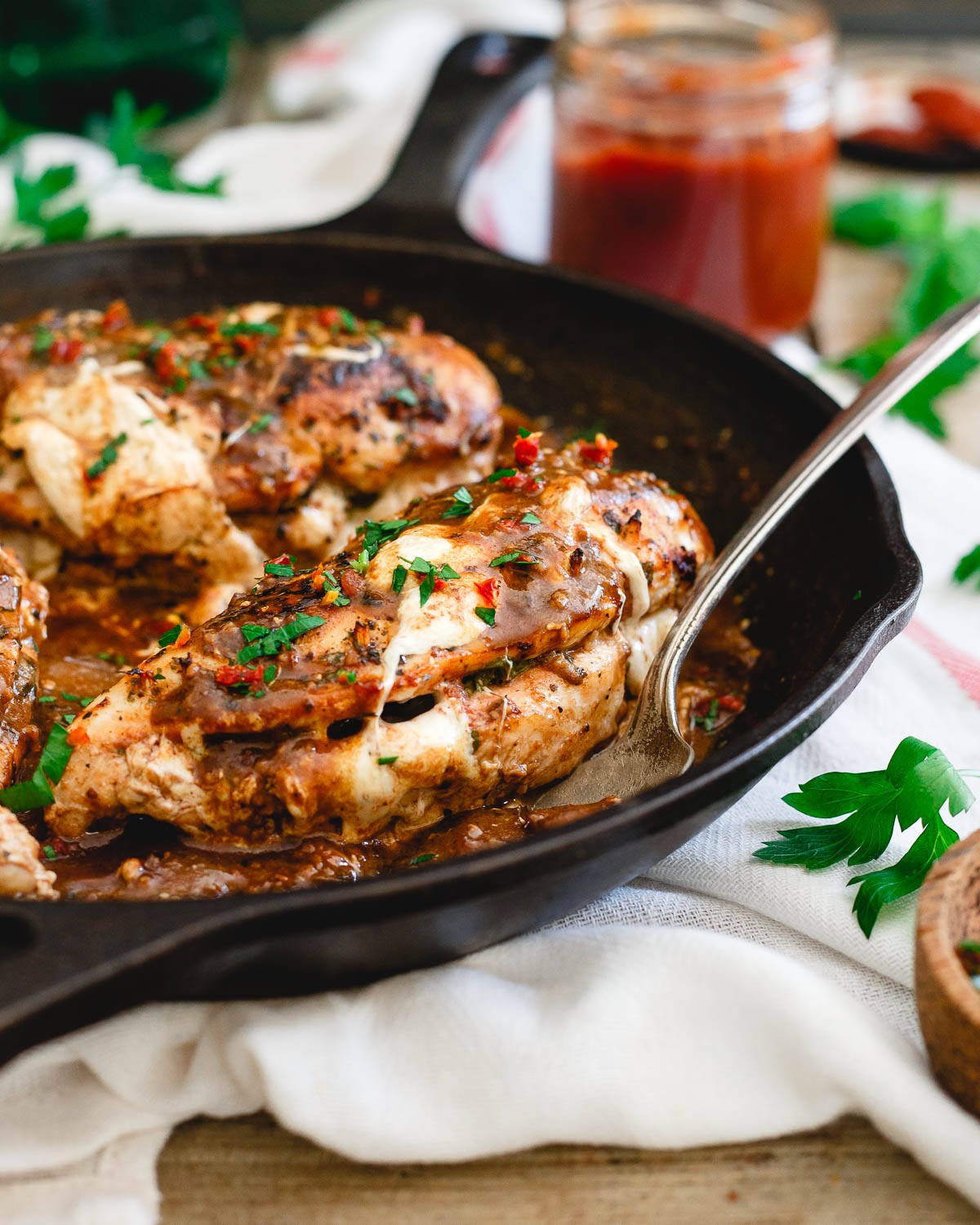 This stuffed chicken marsala is an even more delicious twist on the classic Italian dish with melted mozzarella, sweet and savory tomato butter and fresh basil cooked inside the chicken.