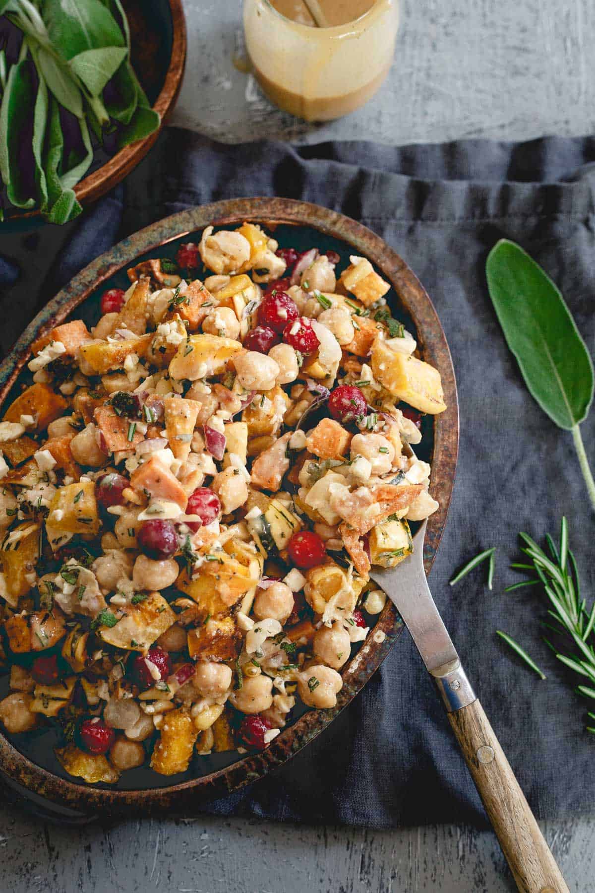 This salad has it all - roasted sweet potatoes, squash, chickpeas, cranberries, feta and a maple tahini dressing for a hearty fall dish packed with flavor.