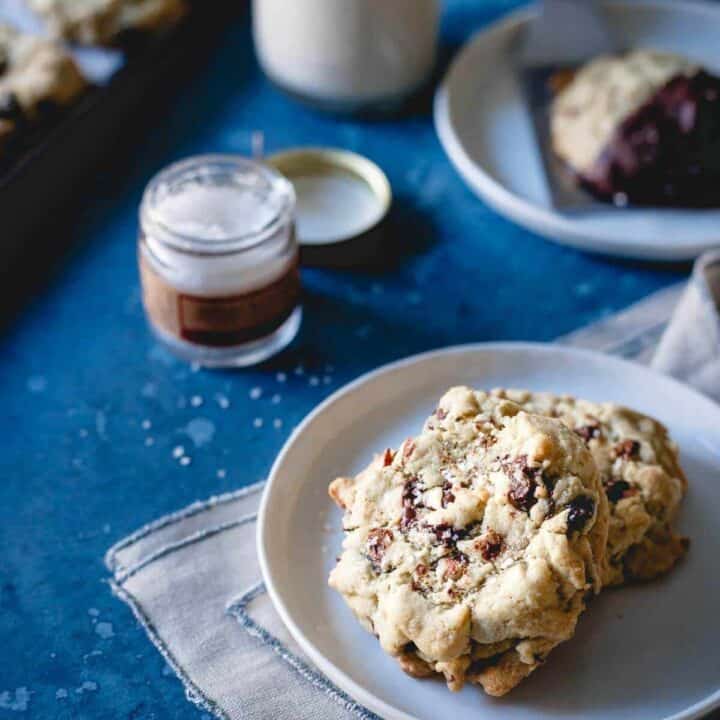 These cranberry almond chocolate chip cookies are infused with orange zest. Dip them in chocolate and sprinkle with sea salt for a gluten-free holiday treat!