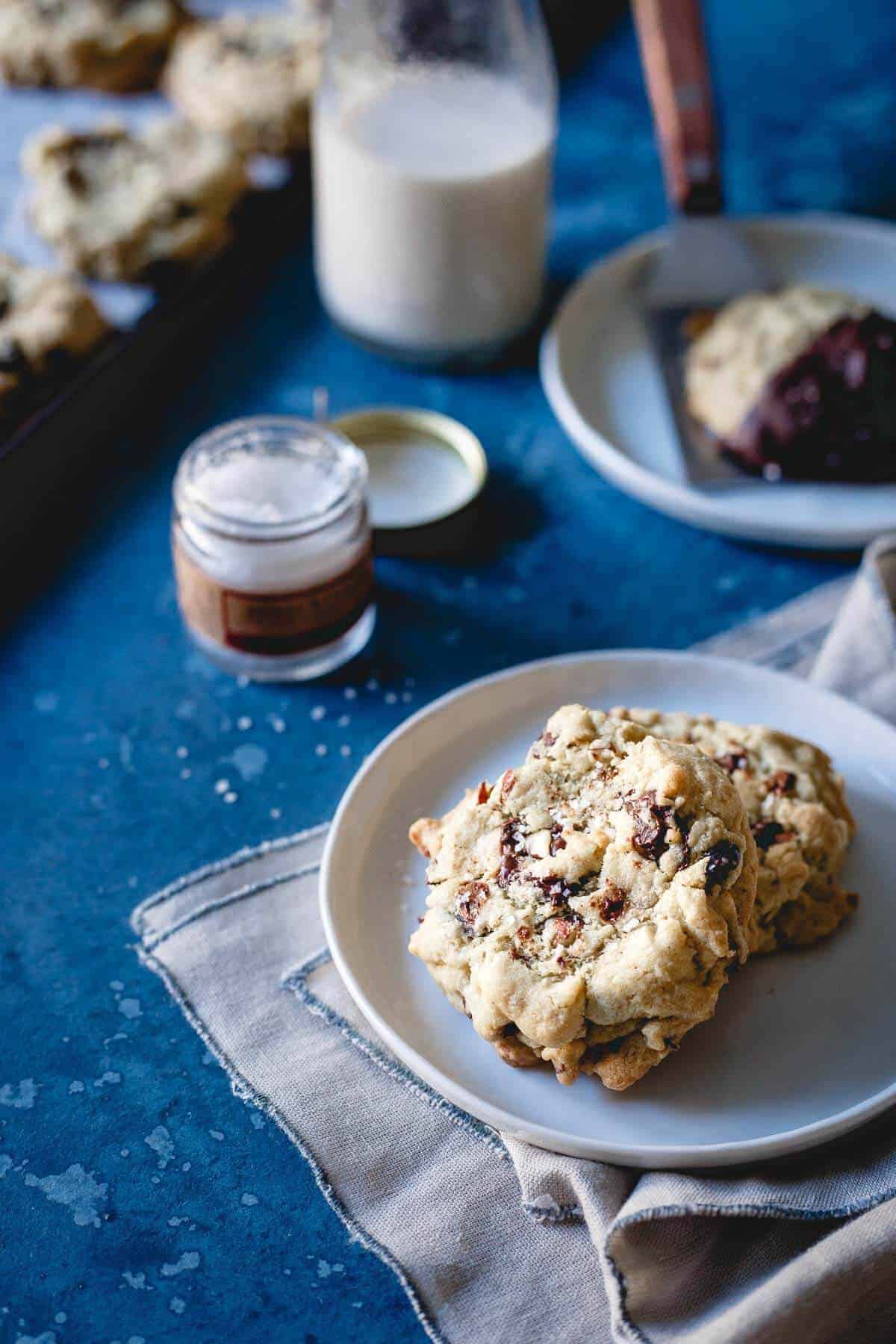 These cranberry almond chocolate chip cookies are infused with orange zest. Dip them in chocolate and sprinkle with sea salt for a gluten-free holiday treat!