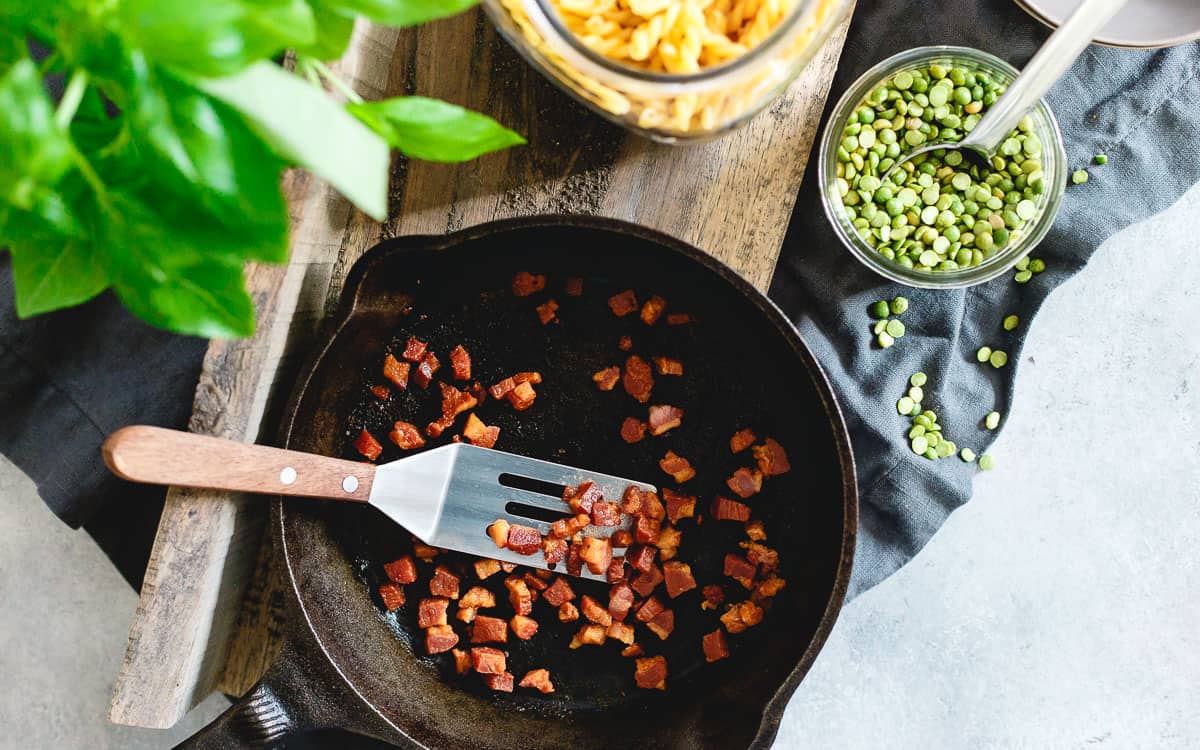 Crispy pan-fried pancetta is the perfect salty addition to this creamy split pea pesto pasta.