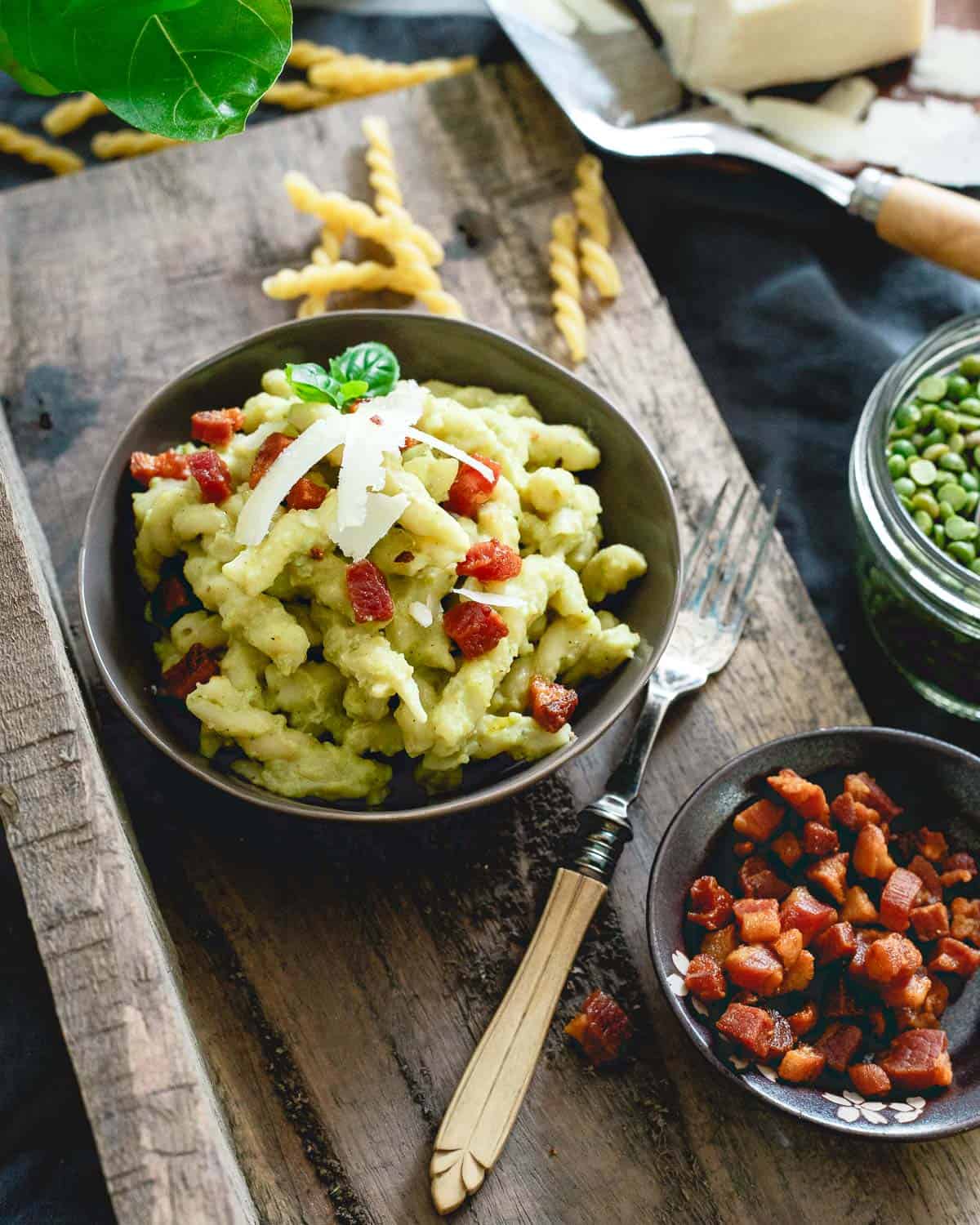 Split pea pesto pasta is made with chewy gemelli spirals, tossed with crispy skillet cooked pancetta and topped with a poached egg - total comfort food.