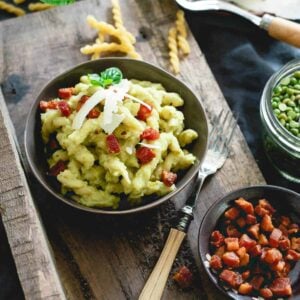 Split pea pesto pasta is made with chewy gemelli spirals, tossed with crispy skillet cooked pancetta and topped with a poached egg - total comfort food.