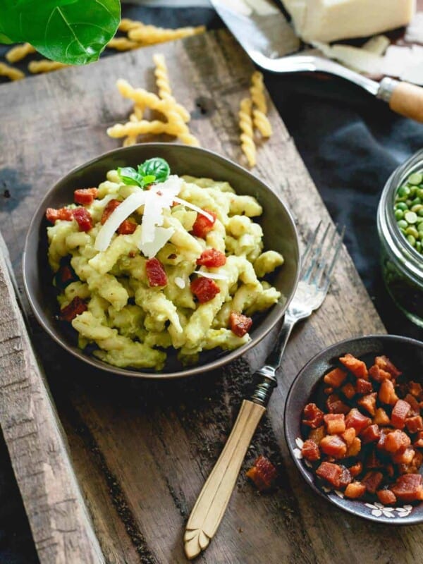 Split pea pesto pasta is made with chewy gemelli spirals, tossed with crispy skillet cooked pancetta and topped with a poached egg - total comfort food.